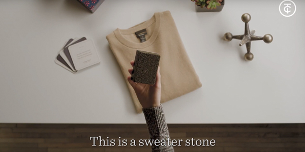 hand holding a square sweater stone above a cream colored sweater. "this is a sweater stone" caption at the bottom