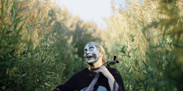 meaner pencil / lenna pierce playing cello in a field of tall grass